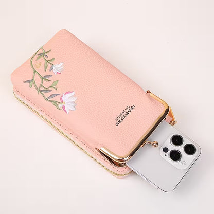 Pink phone case with floral design and zipper, containing a smartphone.