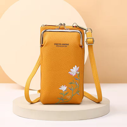 Yellow handbag with floral embroidery on a beige background