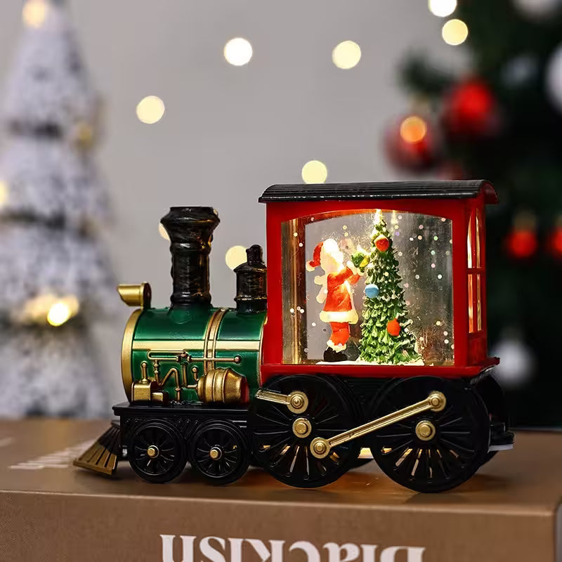 Decorative train with a Santa Claus figure and Christmas tree inside, on a blurred festive background.