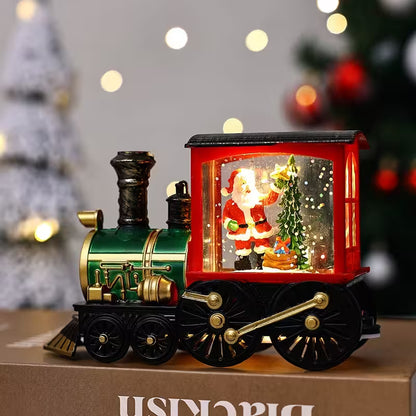 Decorative train with a Santa Claus figure in a glass case, set against a festive background.