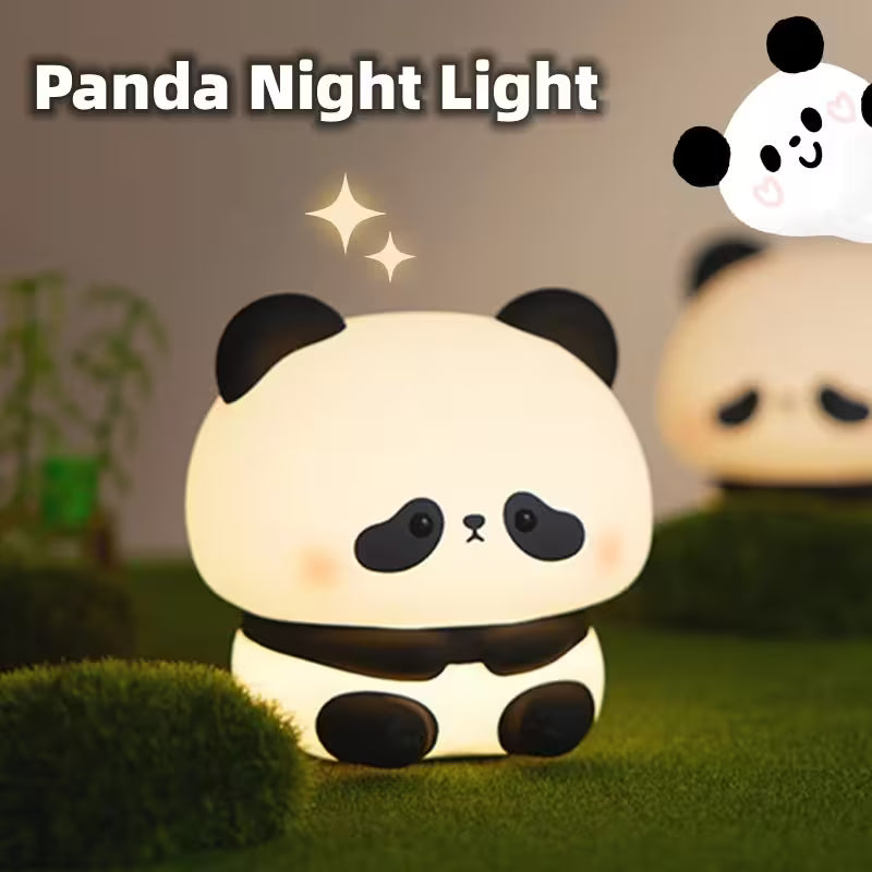 Panda night light on a grassy surface with a blurred background