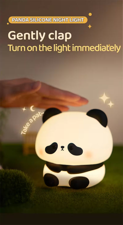 Panda silicone night light with a hand clapping to turn it on, set against a dark background.