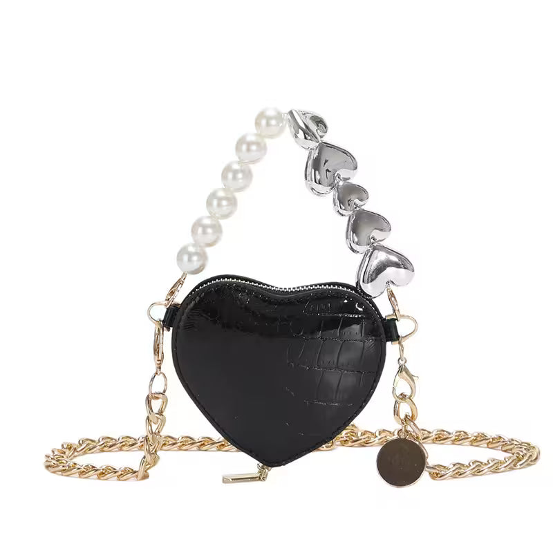 Black heart-shaped purse with pearl and metal chain on a white background