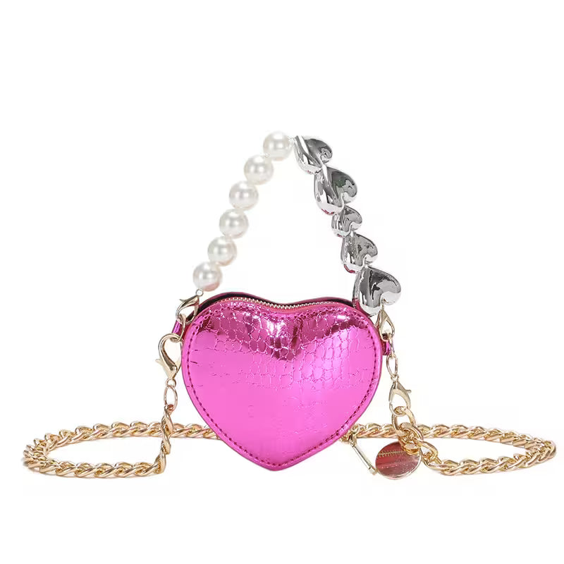 Pink heart-shaped bag with pearl and chain strap on a white background
