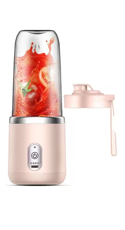 Portable blender with a pink base and clear container filled with a red smoothie on a white background