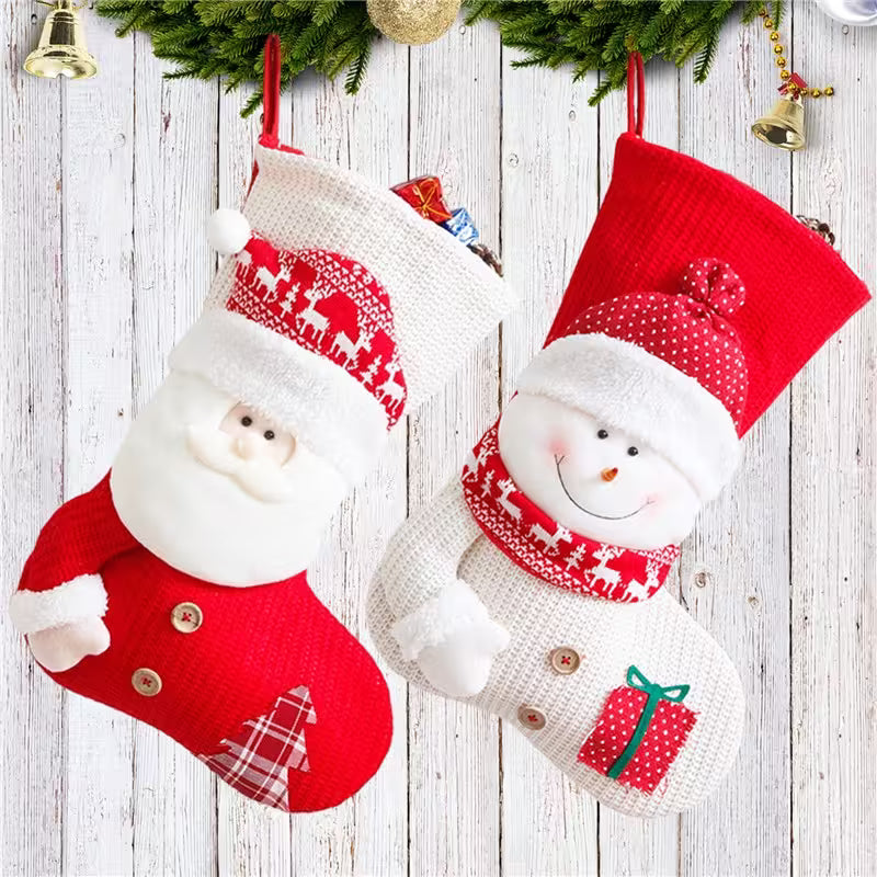 Two Christmas stockings with Santa and snowman designs on a wooden background.