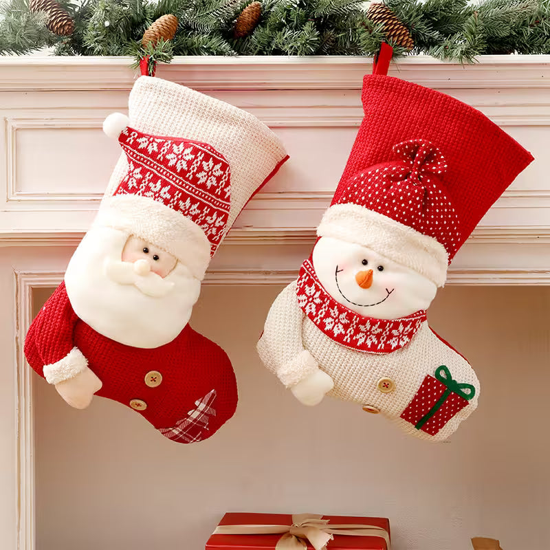 Two Christmas stockings with Santa Claus and snowman designs hanging on a fireplace.