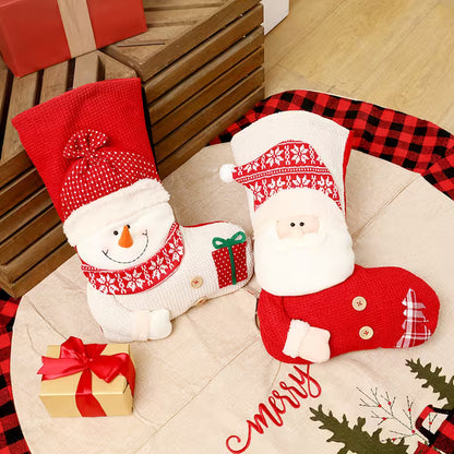 Two Christmas-themed stockings, one with a snowman design and the other with a Santa Claus design, on a couch.