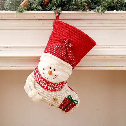 Red Christmas stocking with snowman design hanging on a fireplace mantle.