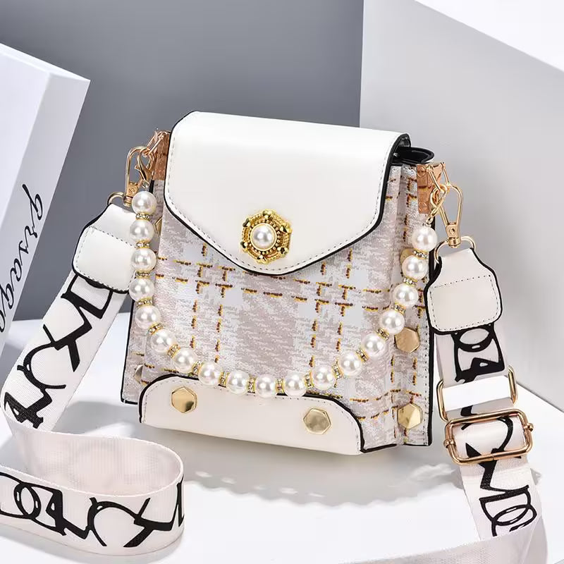 White handbag with pearl embellishments on a white background