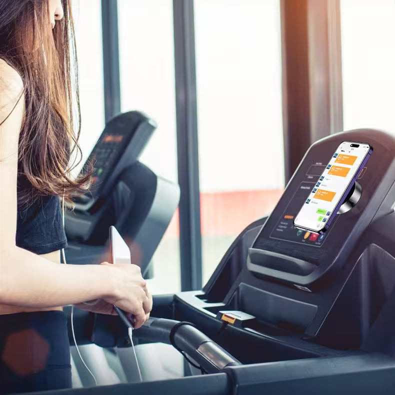Person using a treadmill with a smartphone app displayed on the console.