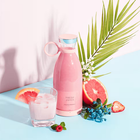 Pink bottle labeled 'Fresh Juice' with a glass of pink drink, grapefruit, and strawberry on a light blue background.