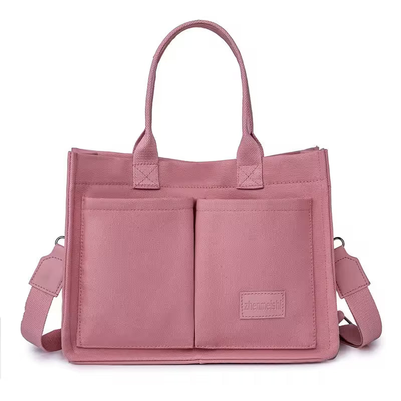 Pink tote bag with a strap on a white background