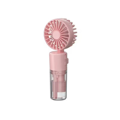 Pink handheld fan with clear base on a white background