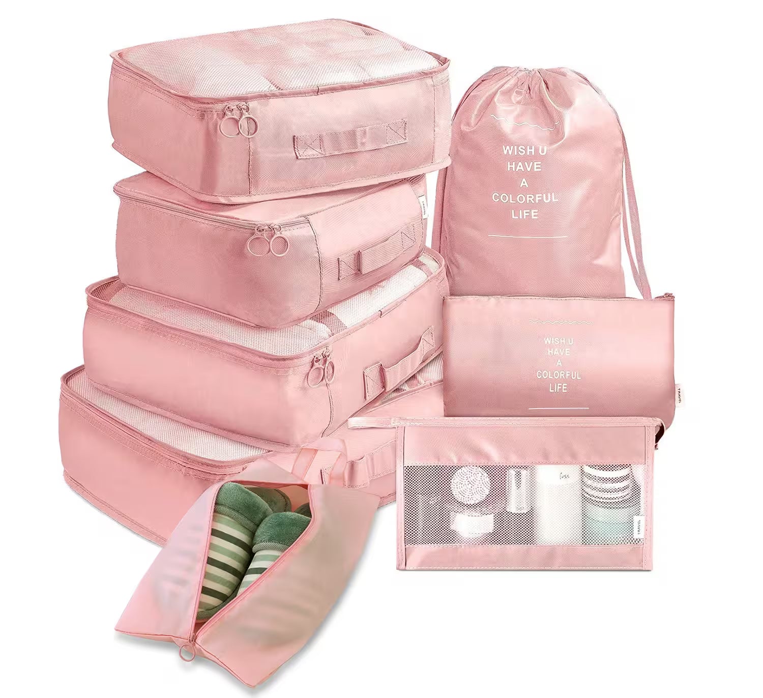 Set of pink travel packing cubes with drawstring bag on a white background