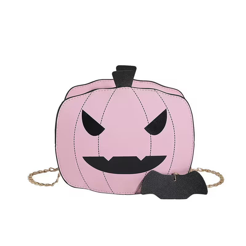 Pink pumpkin-shaped bag with black face details on a white background