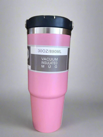 Pink vacuum insulated mug with a black lid on a light gray background