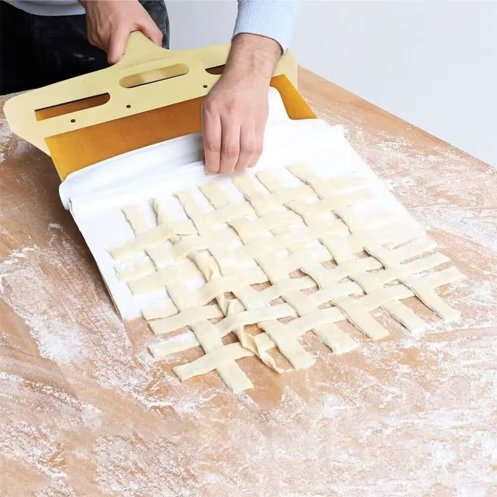 Dough cutting tool being used to create lattice patterns on dough.