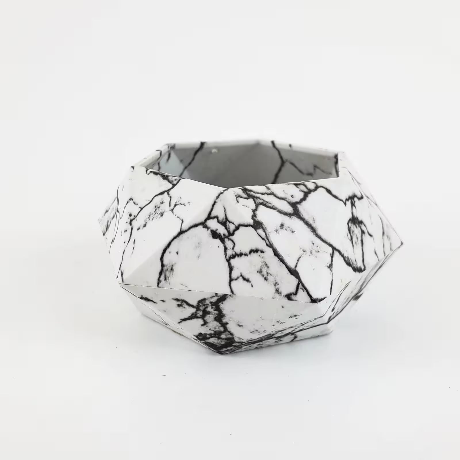 Geometric black and white patterned container on a white background