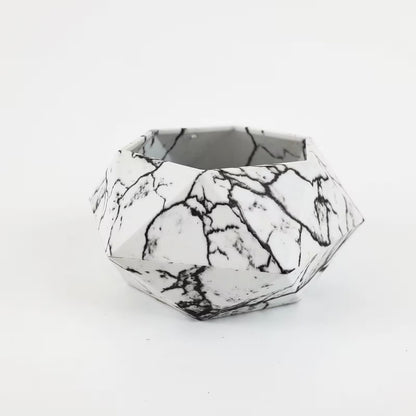 Geometric black and white patterned container on a white background