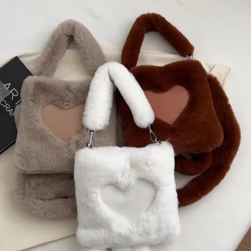 Three fluffy handbags in gray, white, and brown with heart designs on a light background.