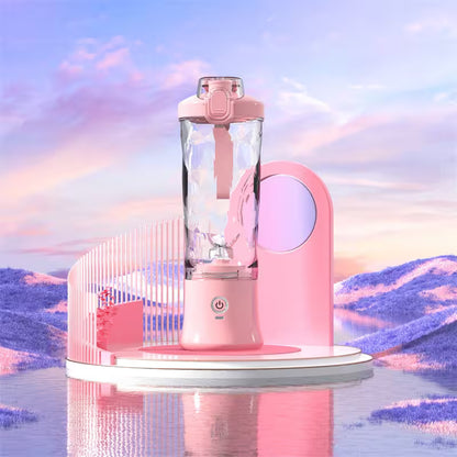 Pink blender with a futuristic design on a reflective surface with a mountainous landscape background.