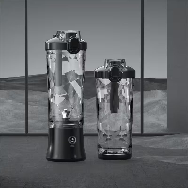 Two portable blenders with geometric patterned blades on a reflective surface.