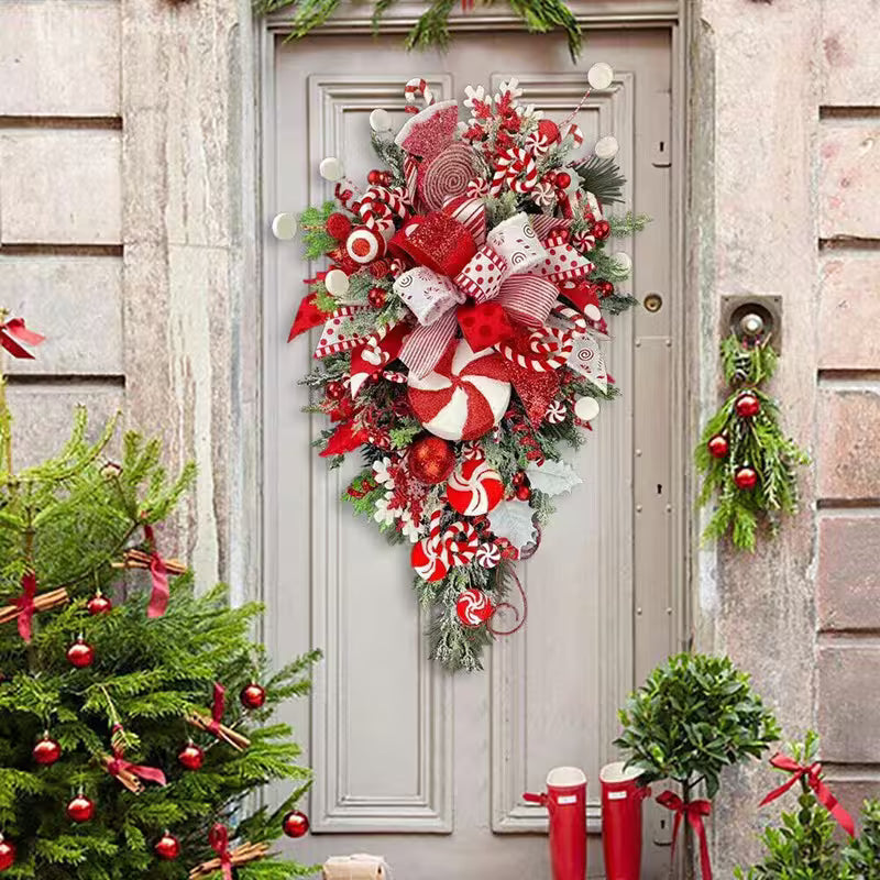 Decorative Christmas wreath on a door with festive decorations around.