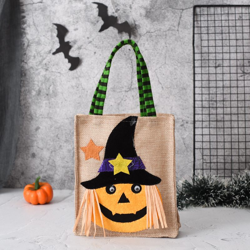 Halloween-themed bag with a pumpkin face design on a gray background with decorative elements.