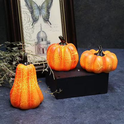 Three decorative pumpkins with a cracked texture on a dark surface, with a framed picture of a butterfly and building in the background.