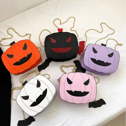 Set of Halloween-themed pumpkin-shaped bags with chain straps on a white surface.