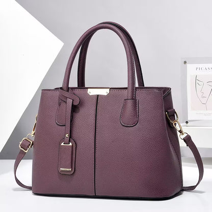 Purple handbag with gold accents on a white background