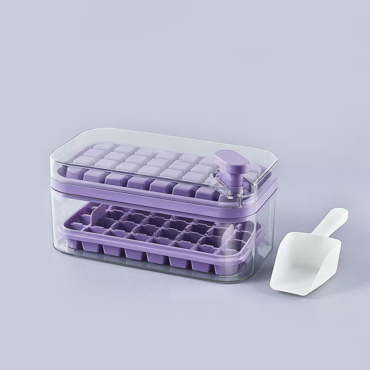 Purple ice cube tray with clear lid and white scoop on a light gray background