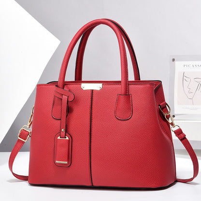 Red handbag with gold accents on a white background
