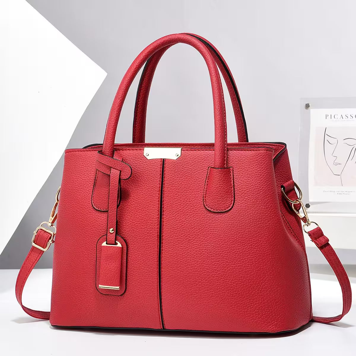 Red handbag with gold accents on a white background