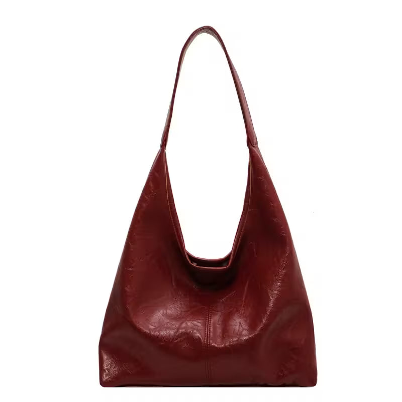 Red leather handbag on a white background