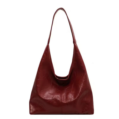Red leather handbag on a white background