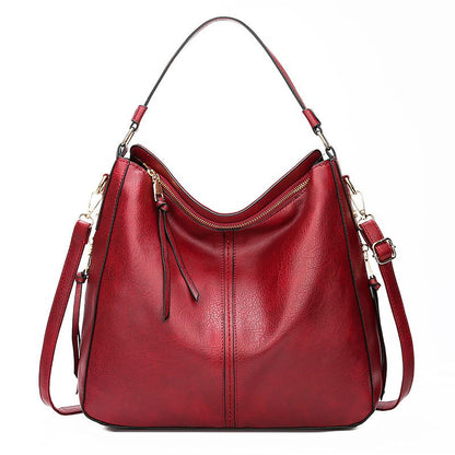 Red handbag with gold accents on a white background