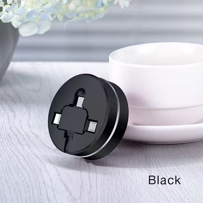 Black plug adapter on a light surface with a white cable and blurred flowers in the background