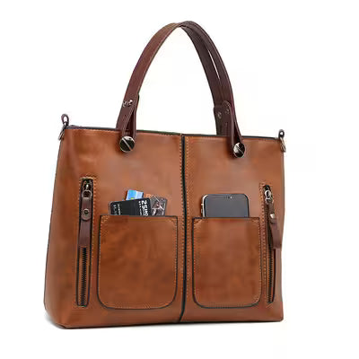 Brown leather handbag with multiple pockets on a white background
