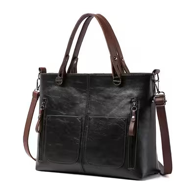 Black leather handbag with brown straps on a white background