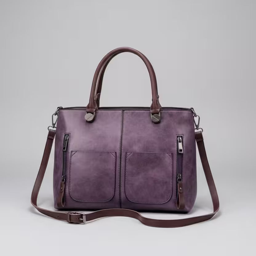 Purple handbag with a shoulder strap on a light gray background