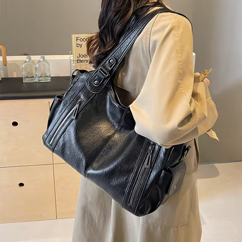 Person wearing a black leather backpack in an indoor setting