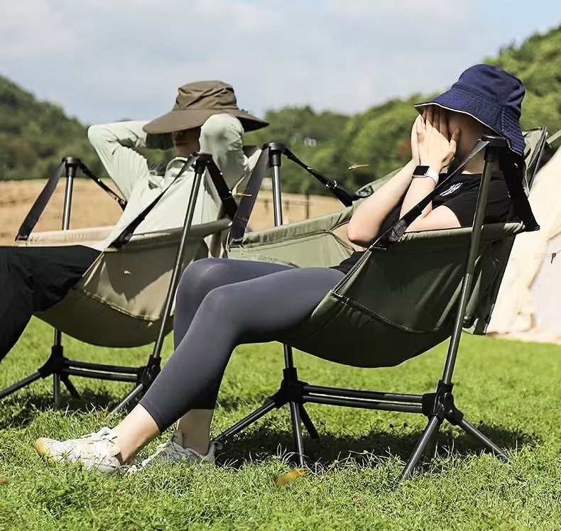 Person sitting in a camping chair with a scenic background