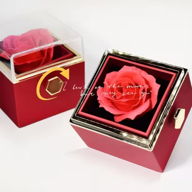 Red jewelry box with a pink rose and engraved text on a white background