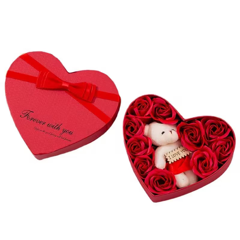 Heart-shaped red gift box with a teddy bear and roses on a white background