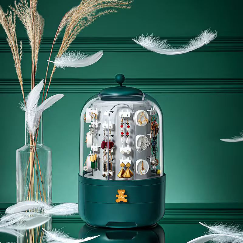 Jewelry display case with earrings on a green background