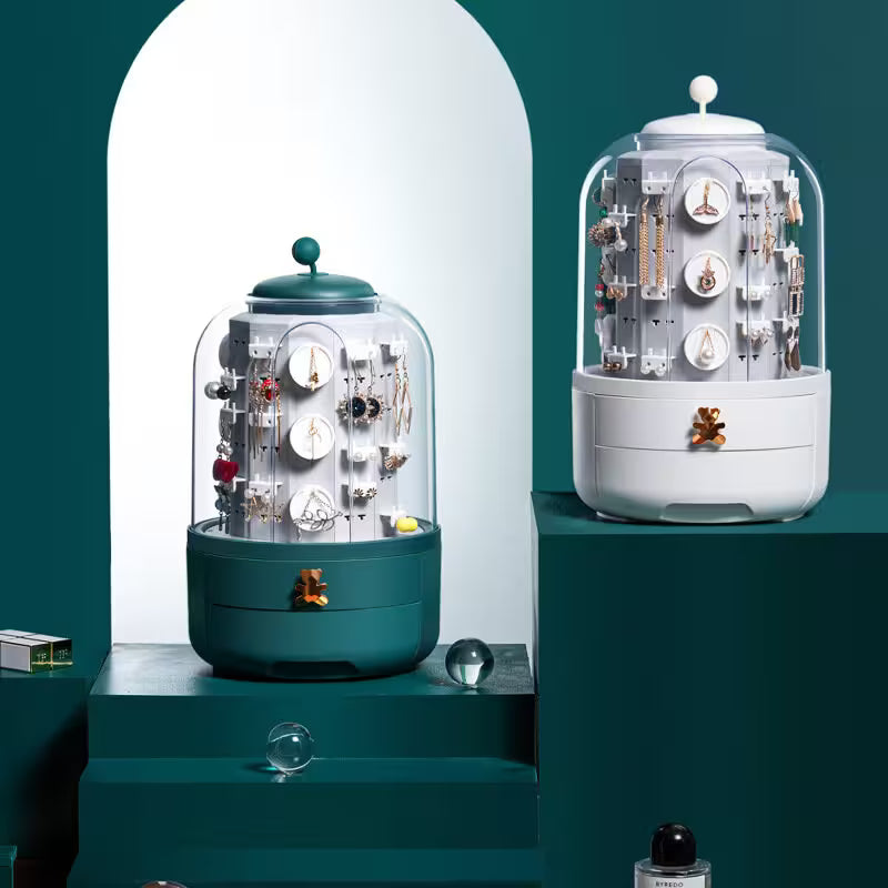 Two decorative displays with clear domes on a teal background