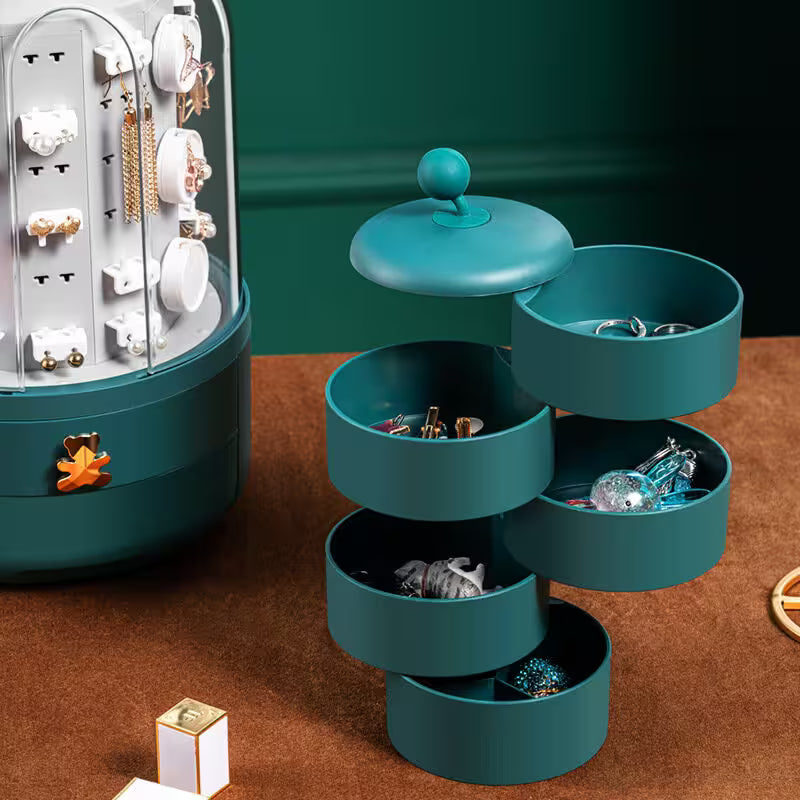 Teal jewelry organizer with various earrings on a brown surface