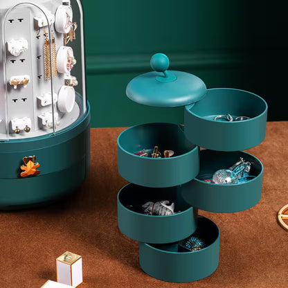 Teal jewelry organizer with various earrings on a brown surface